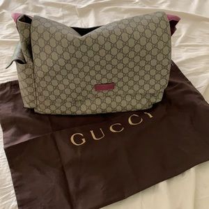 Gucci diaper bag with a pink handle changing pad
